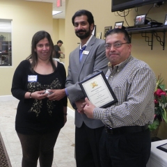 Neelam and Sal receiving special recognition plaque and gift for high scores on Trimark programs